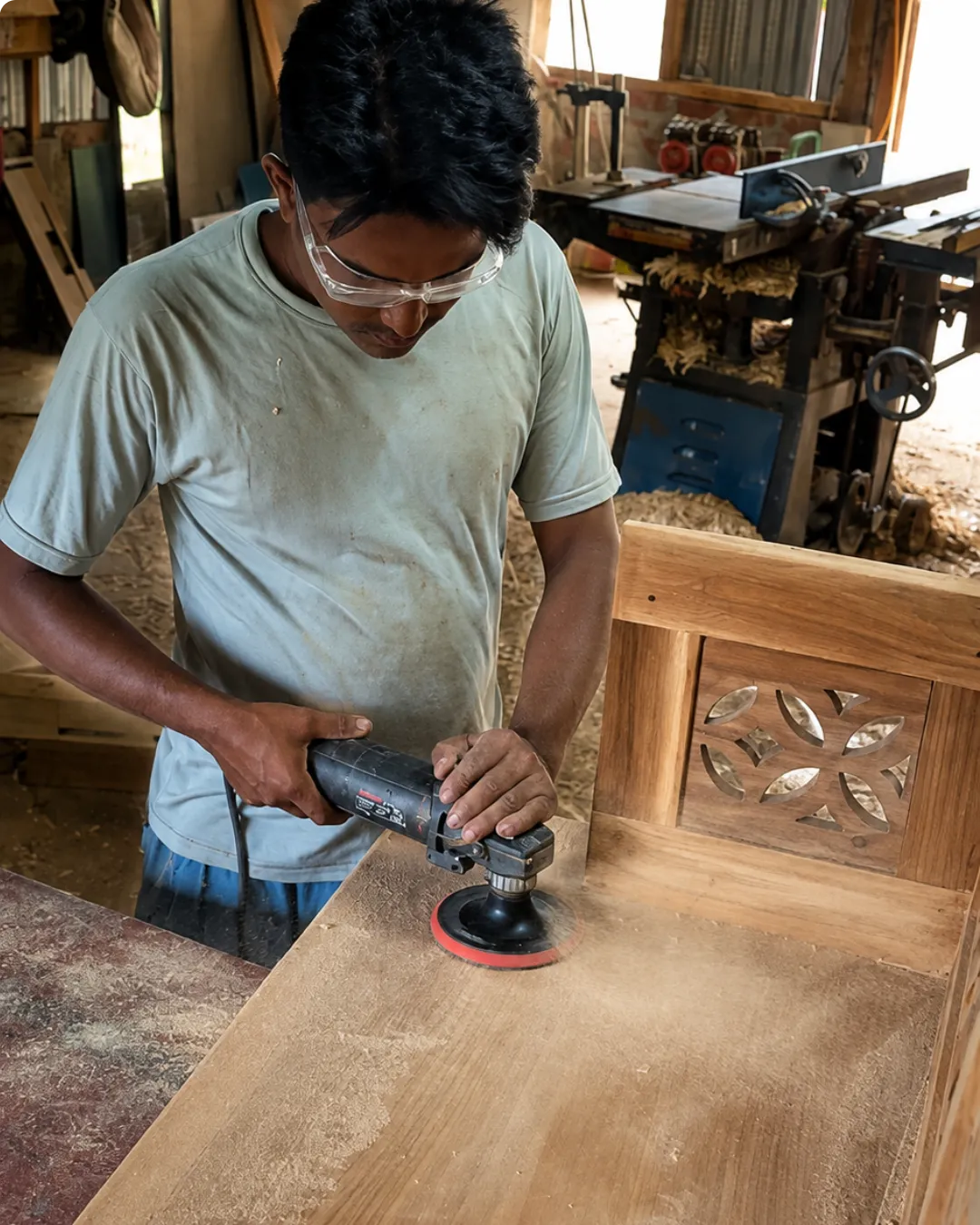 Artisan applying premium finish to custom teak wood furniture in Itanagar