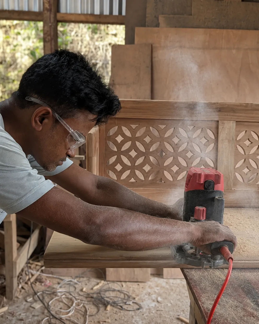 Artisan applying premium finish to custom teak wood furniture in Itanagar