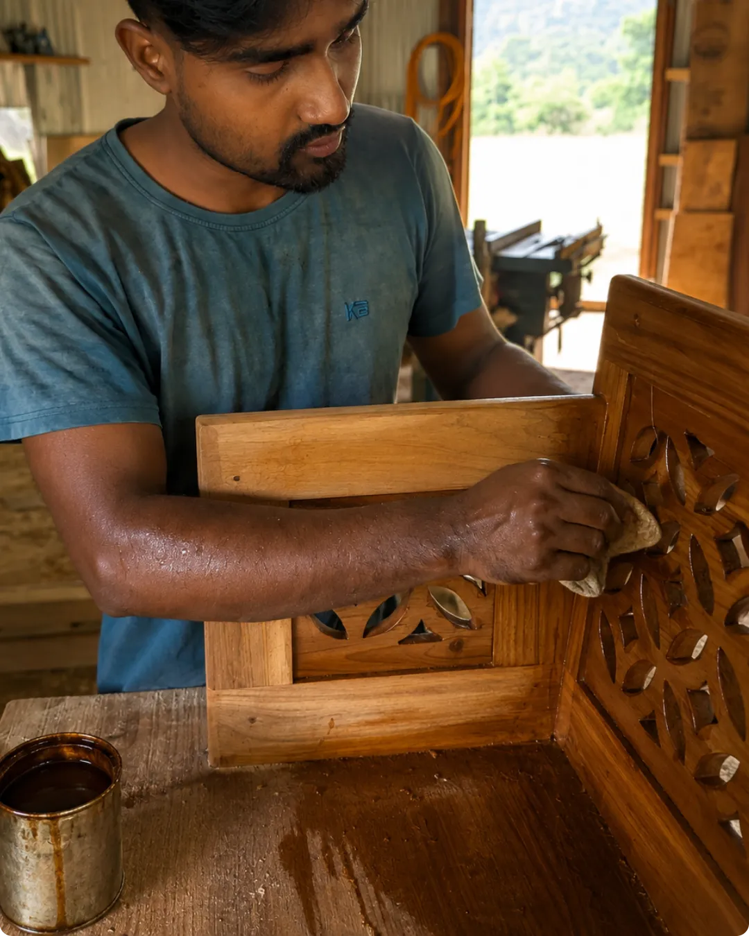 Artisan applying premium finish to custom teak wood furniture in Itanagar