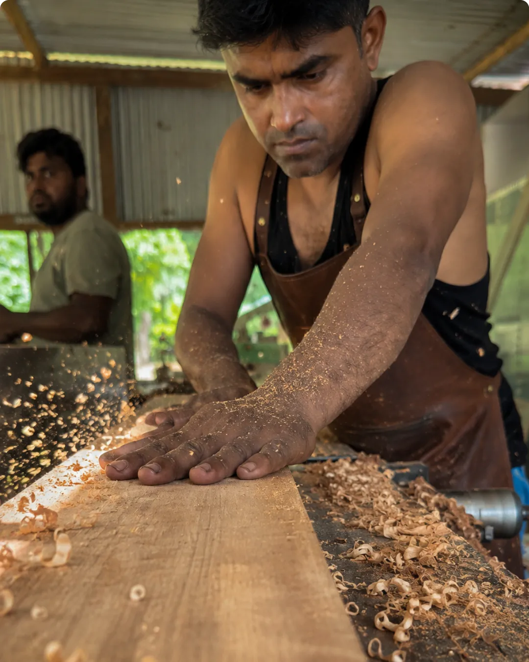 Artisan applying premium finish to custom teak wood furniture in Itanagar